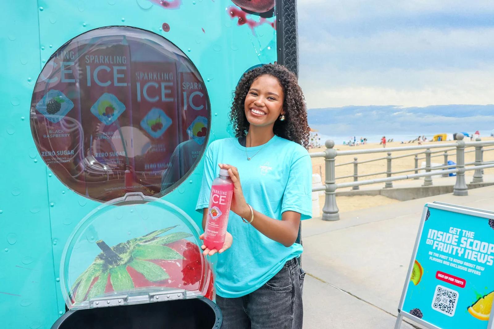 Image of a brand ambassador holding a Sparkling Ice bottle at a beachside sampling activation.webp