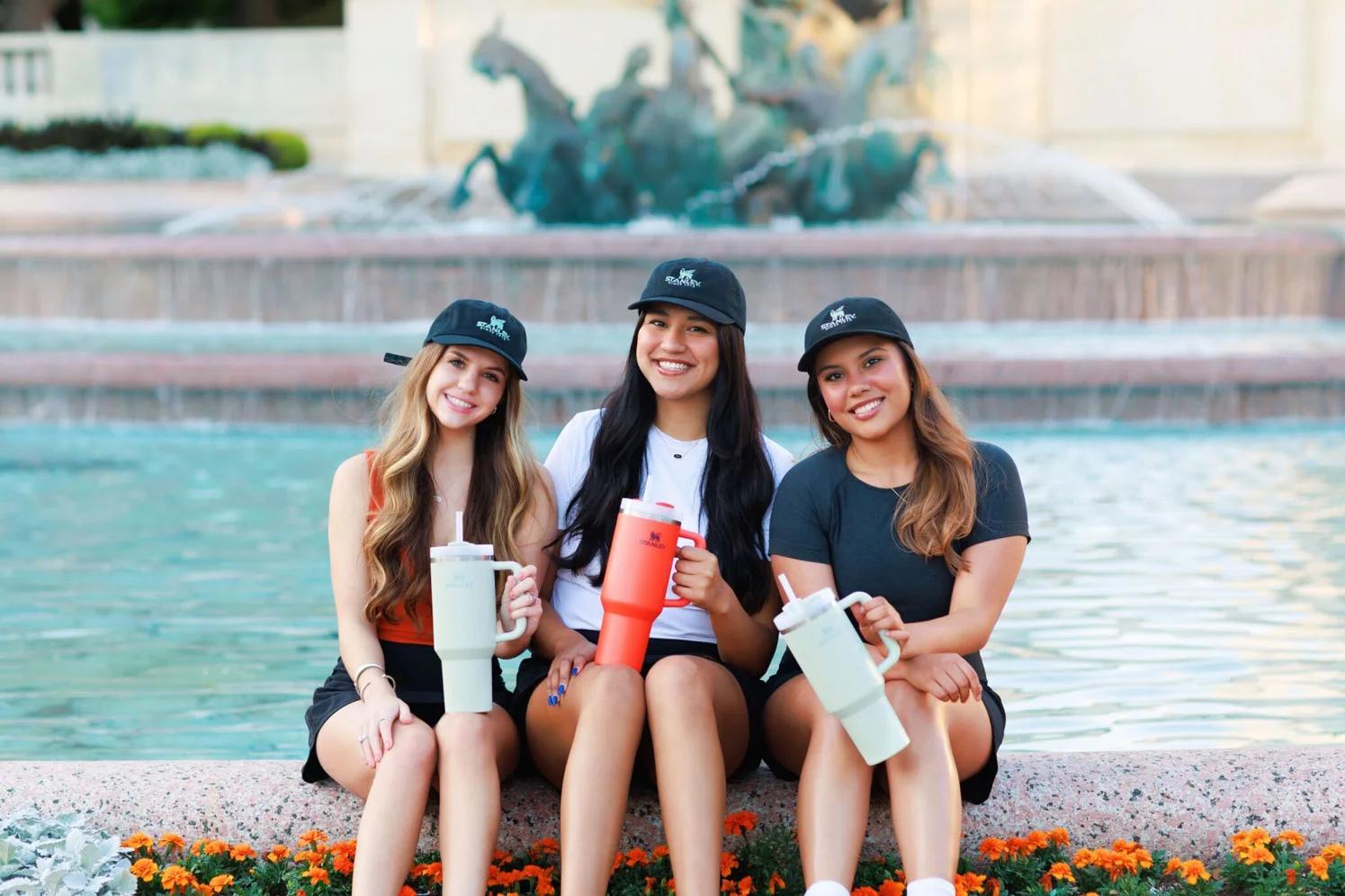 group of college students who are holding Stanley water bottles at a college marketing pop up