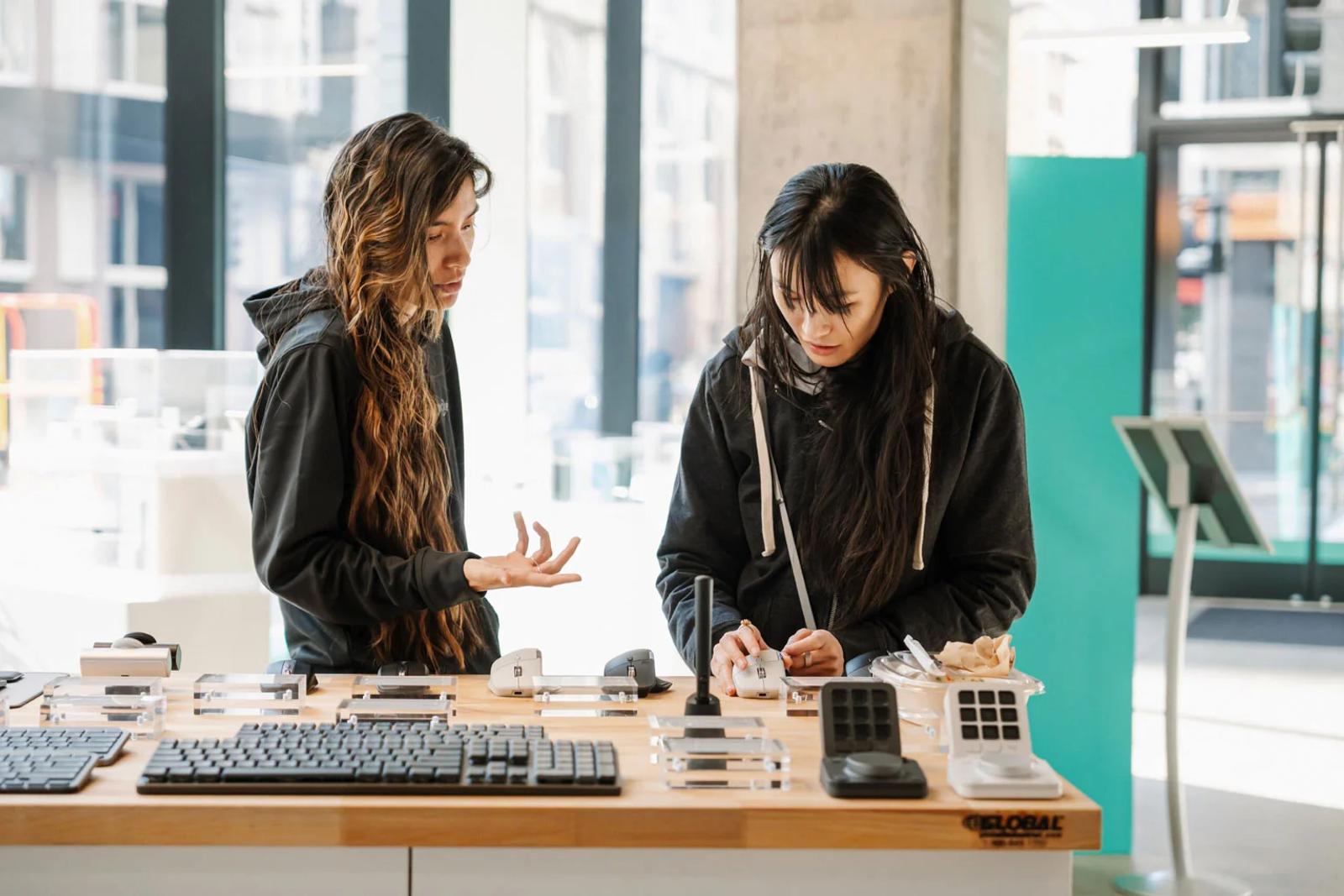 2 woman working on a table 