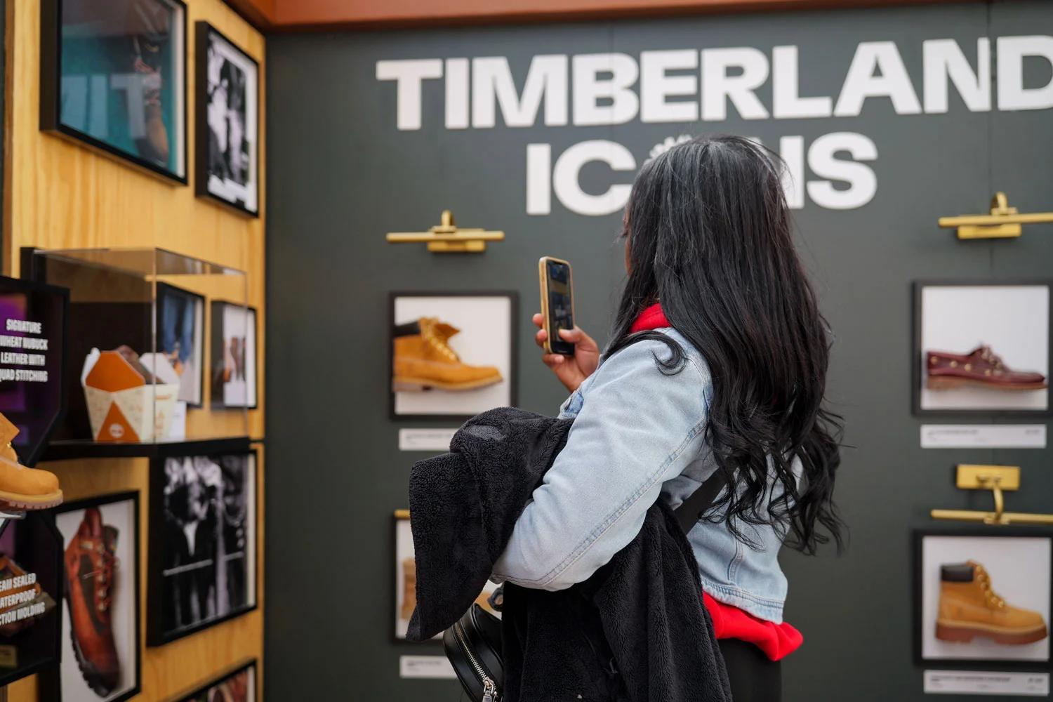 Image of a team celebrating a Timberland store opening with a ribbon-cutting ceremony in a shopping mall
