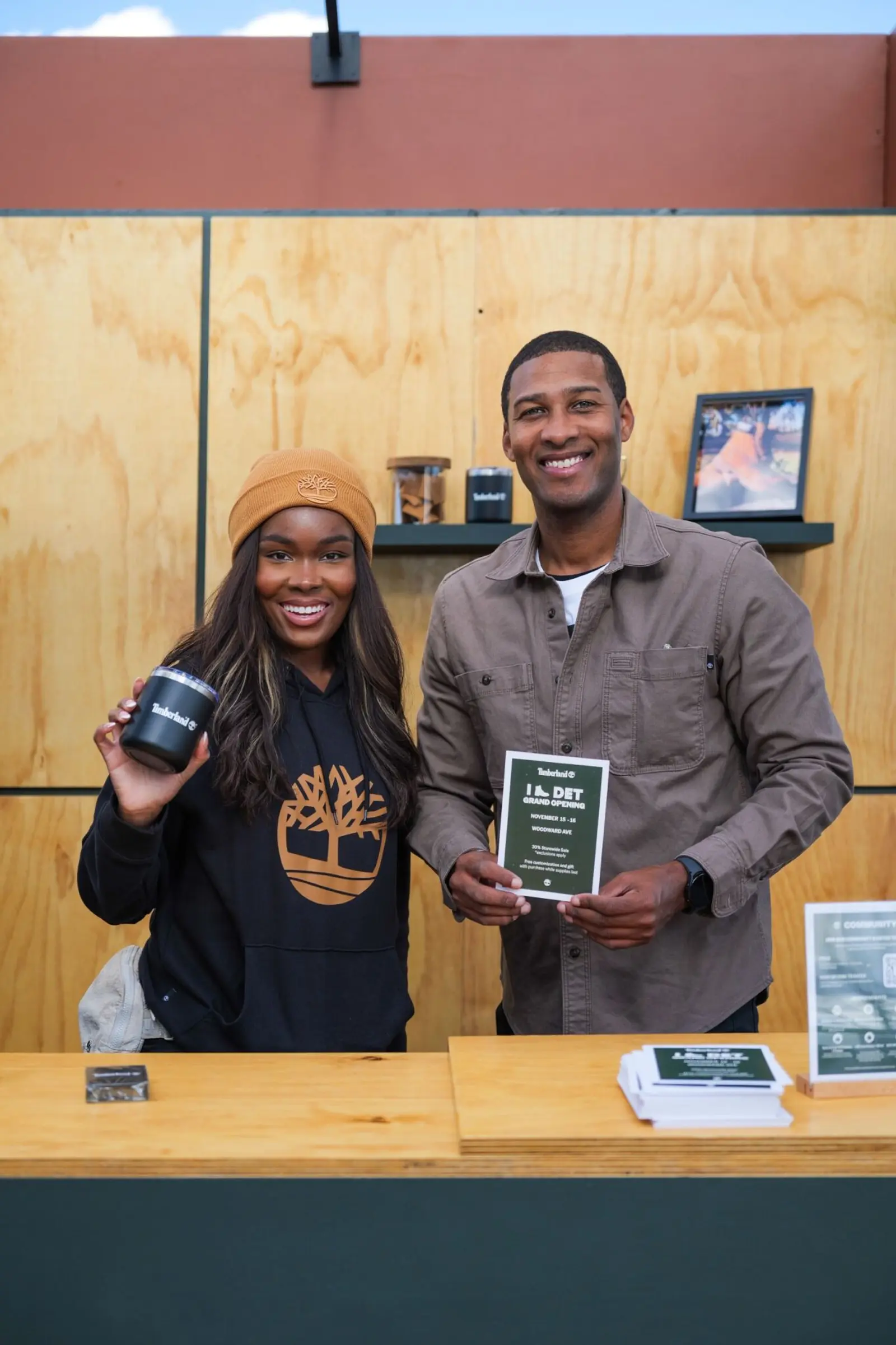 Image of two brand ambassadors promoting a retail grand opening at a branded event counter