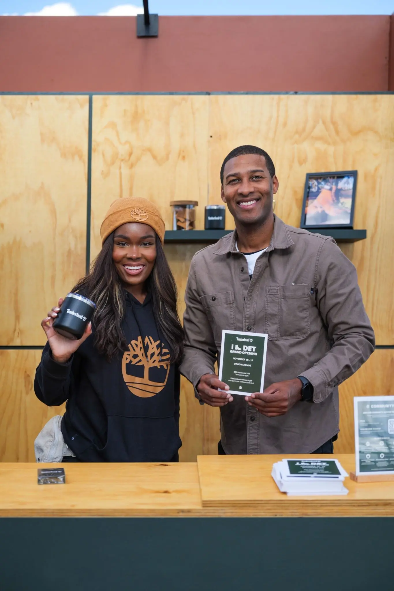Image of two brand ambassadors promoting a retail grand opening at a branded event counter