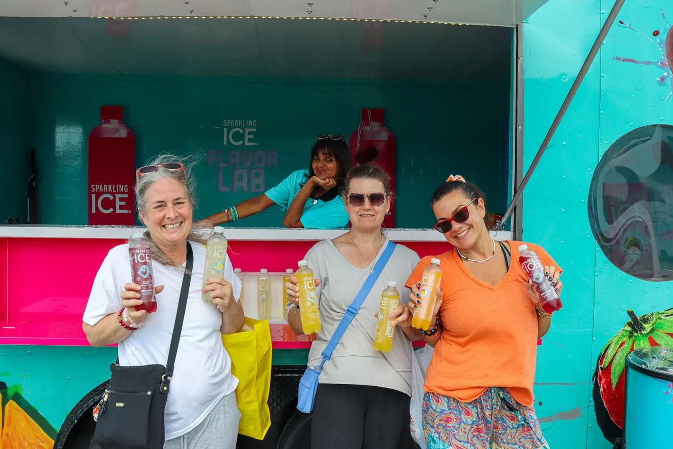 Image of consumers posing with samples at a Sparkling Ice mobile brand activation strategy event