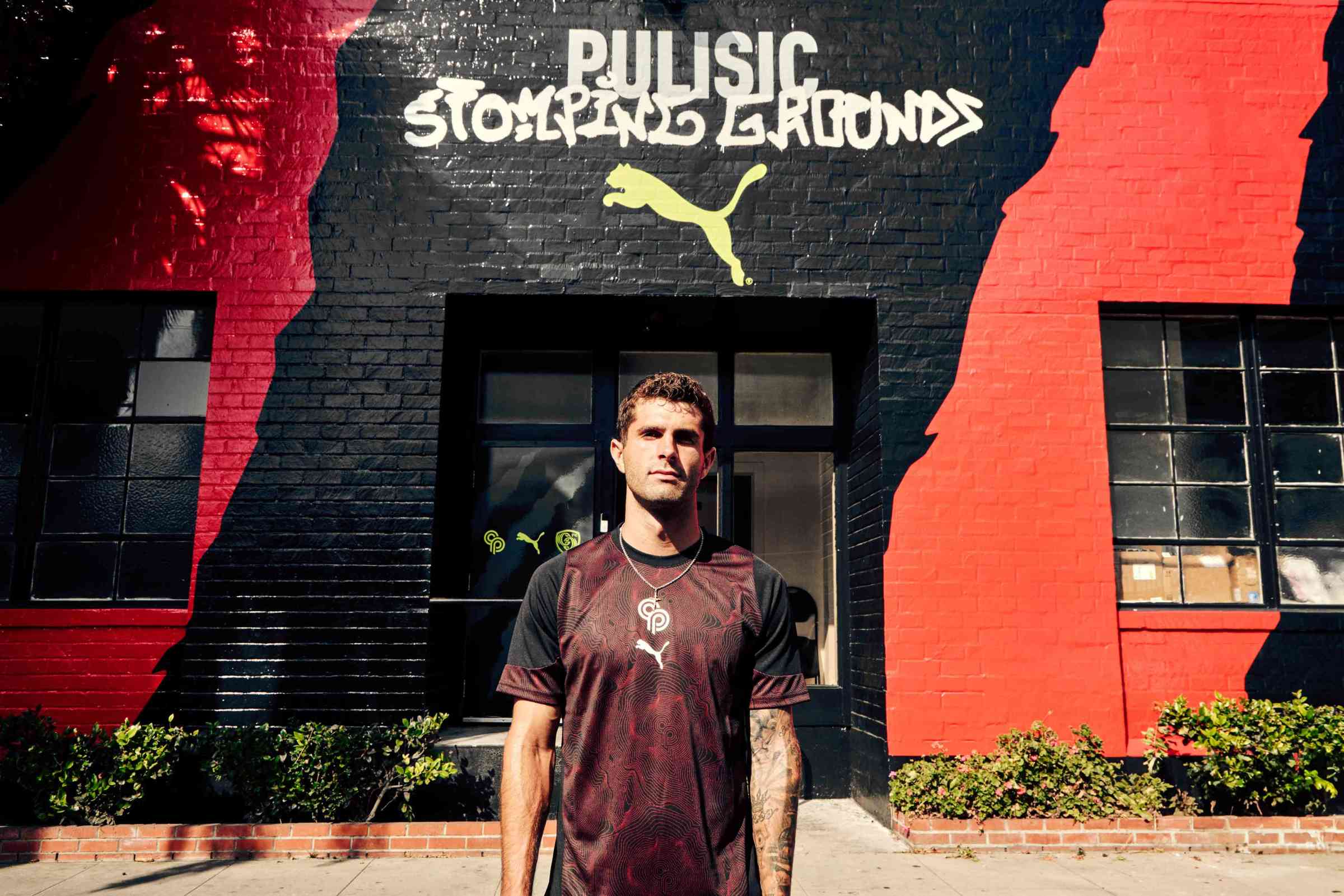 Christian Pulisic in front of the Stomping Grounds building