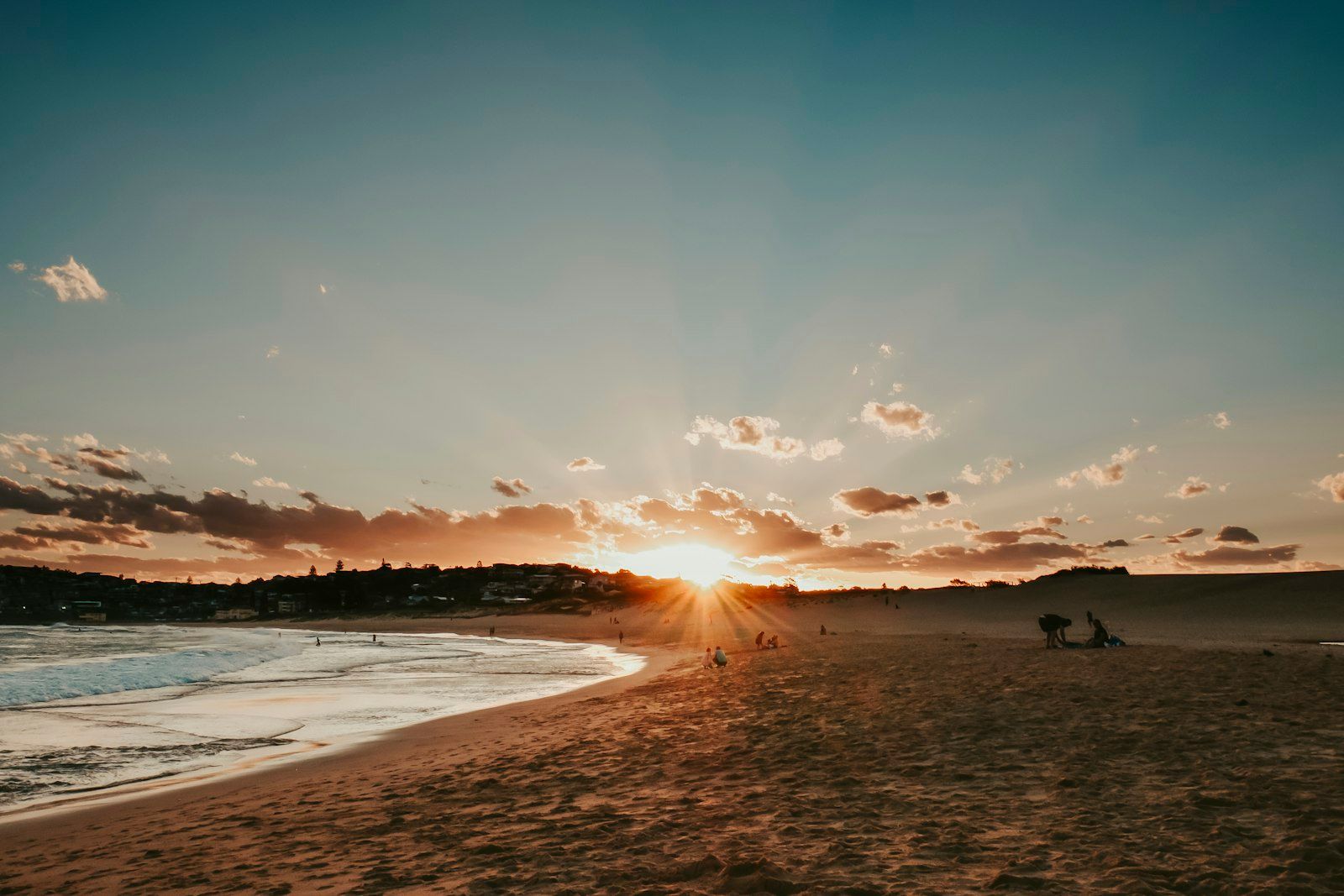 silhouette of people on beach during sunset