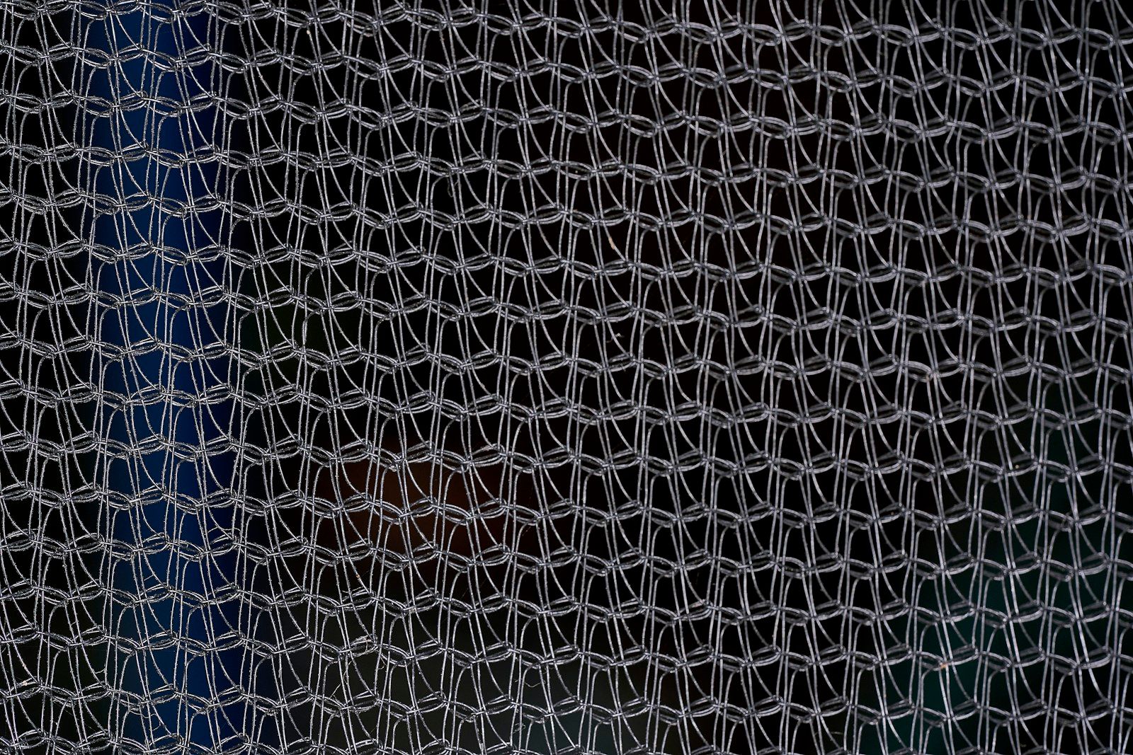 a close up of a net with a blue sky in the background