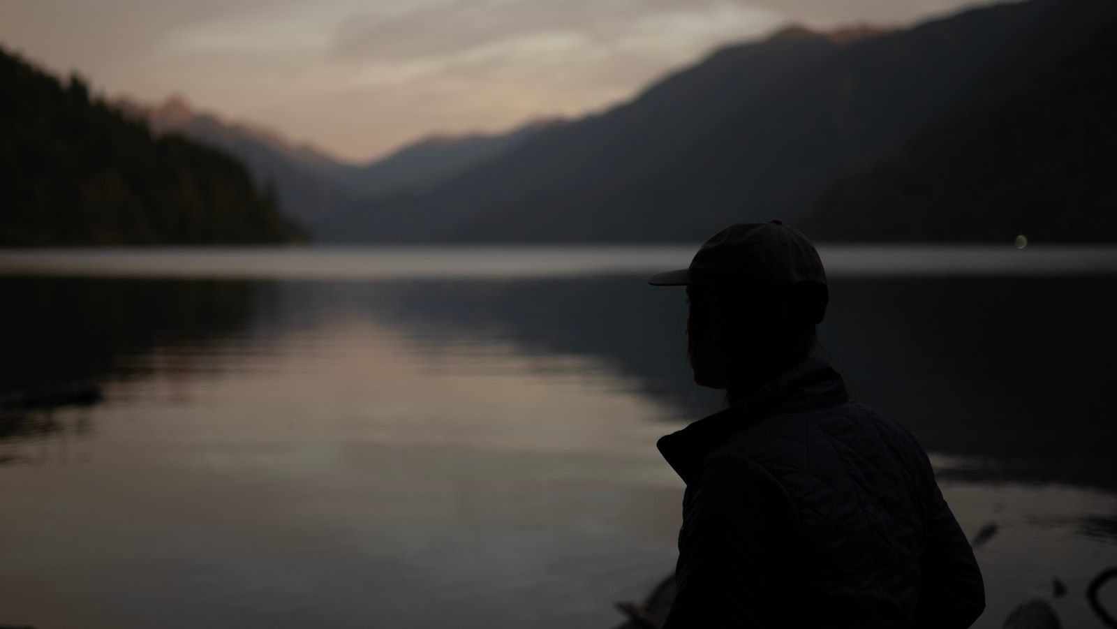 A person standing in front of a body of water