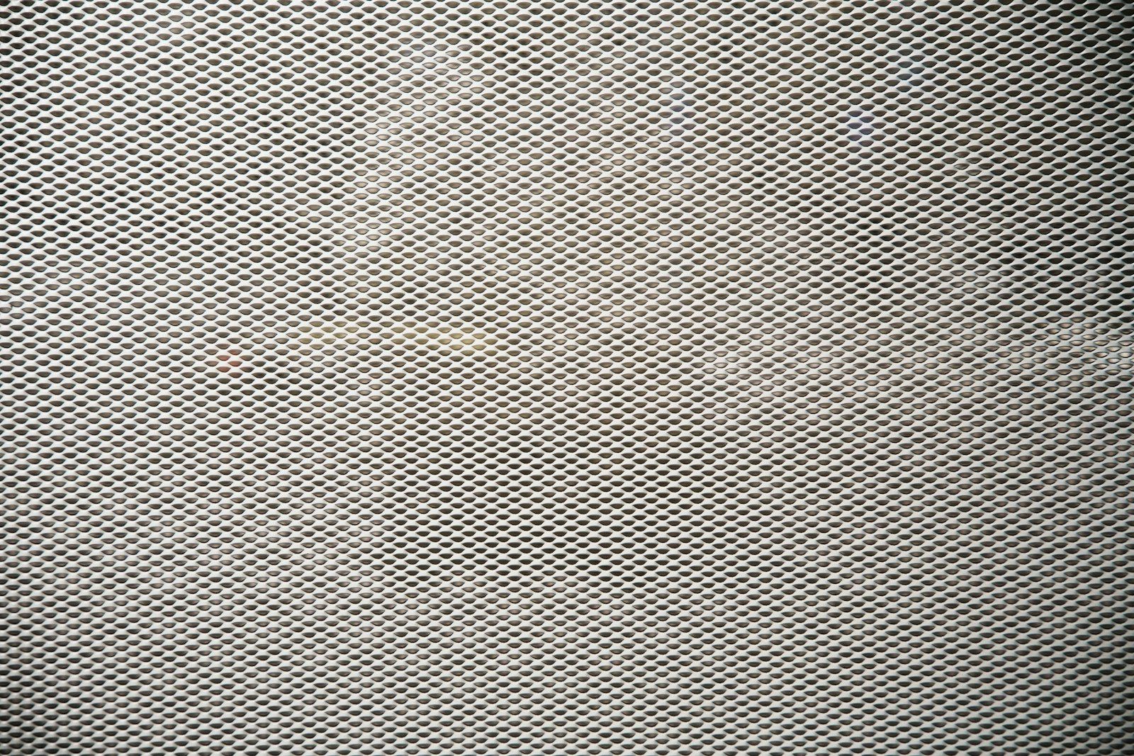 A black and white photo of a metal screen