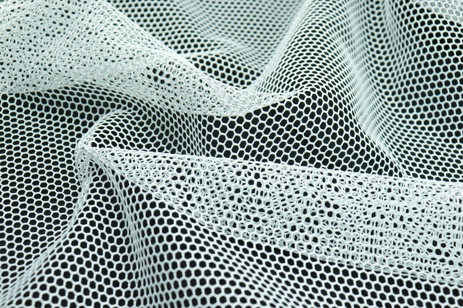 a close up of a black and white mesh