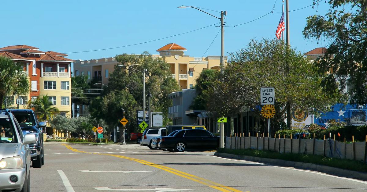 108th Avenue in Treasure Island, Florida, with mid-rise buildings and a 20 mph speed limit sign