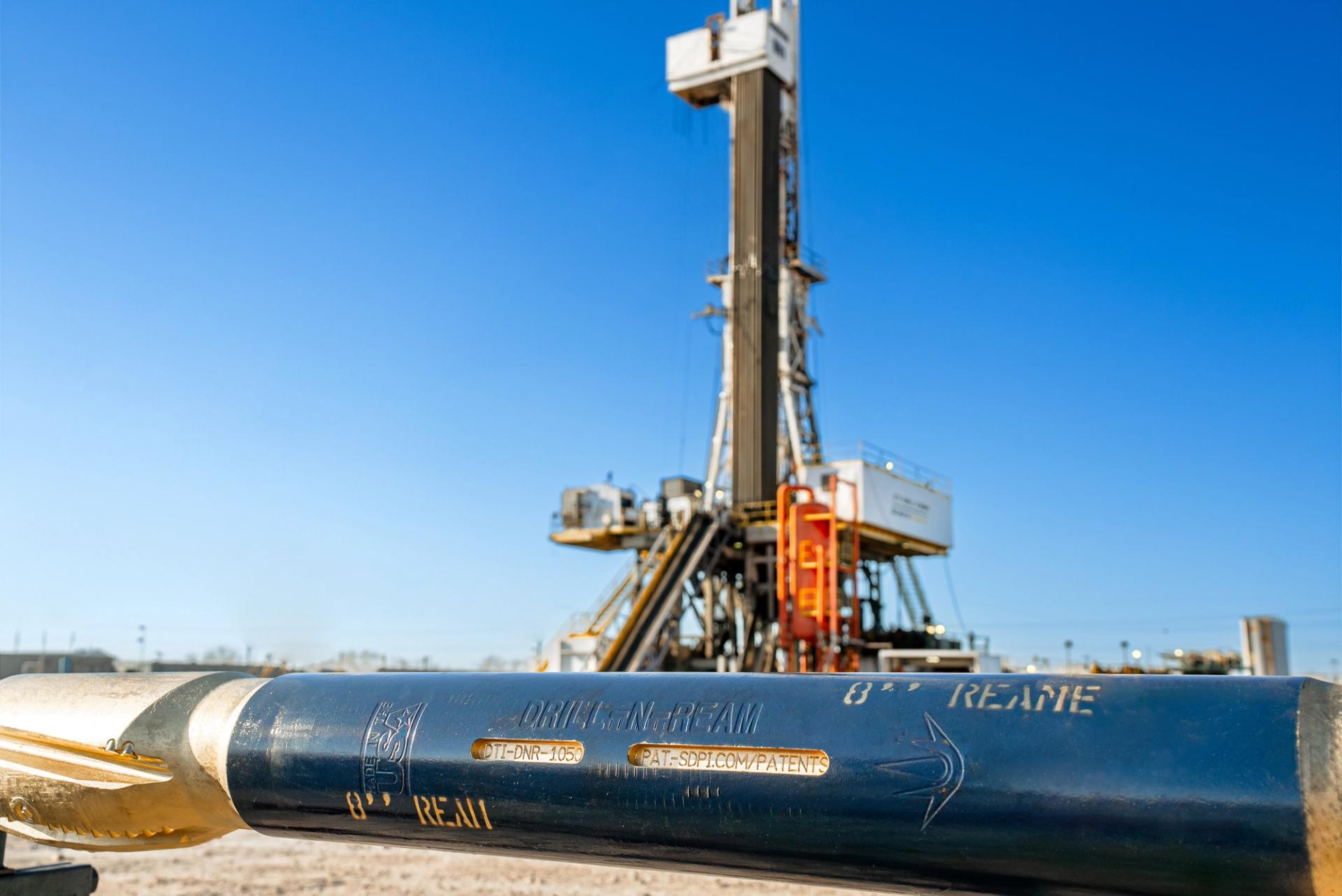 A technician inspecting a drilling tool.