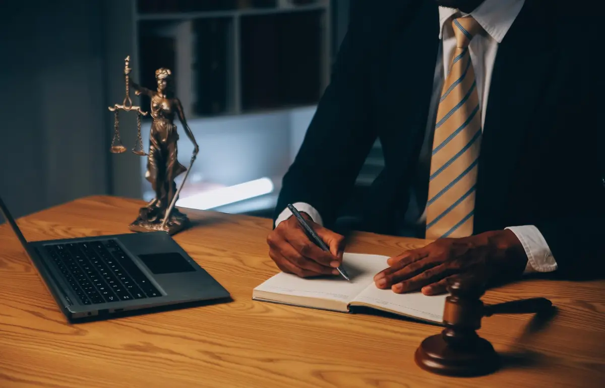 Solicitor meeting a client across a desk in a law office
