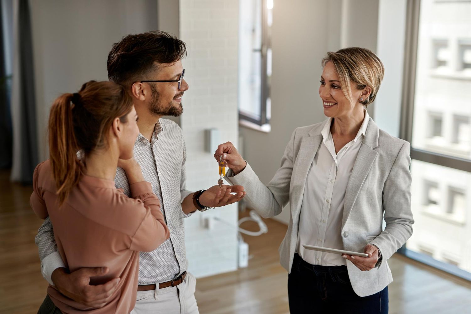 Estate agent showing a property to potential buyers