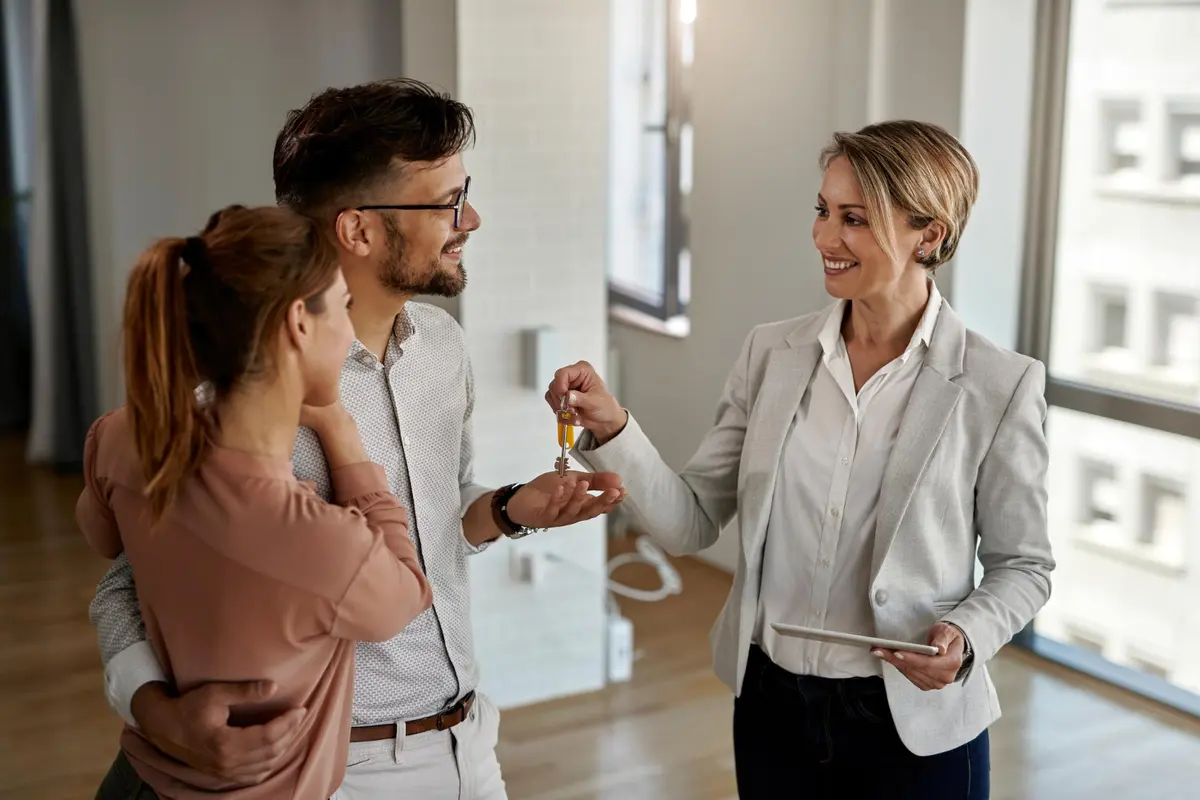Estate agent showing a property to potential buyers