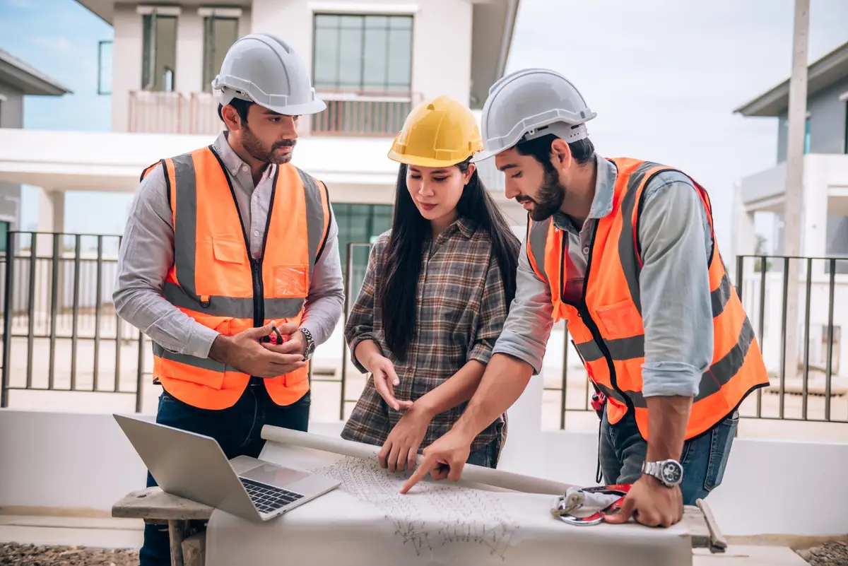 Construction workers on a building site reviewing plans