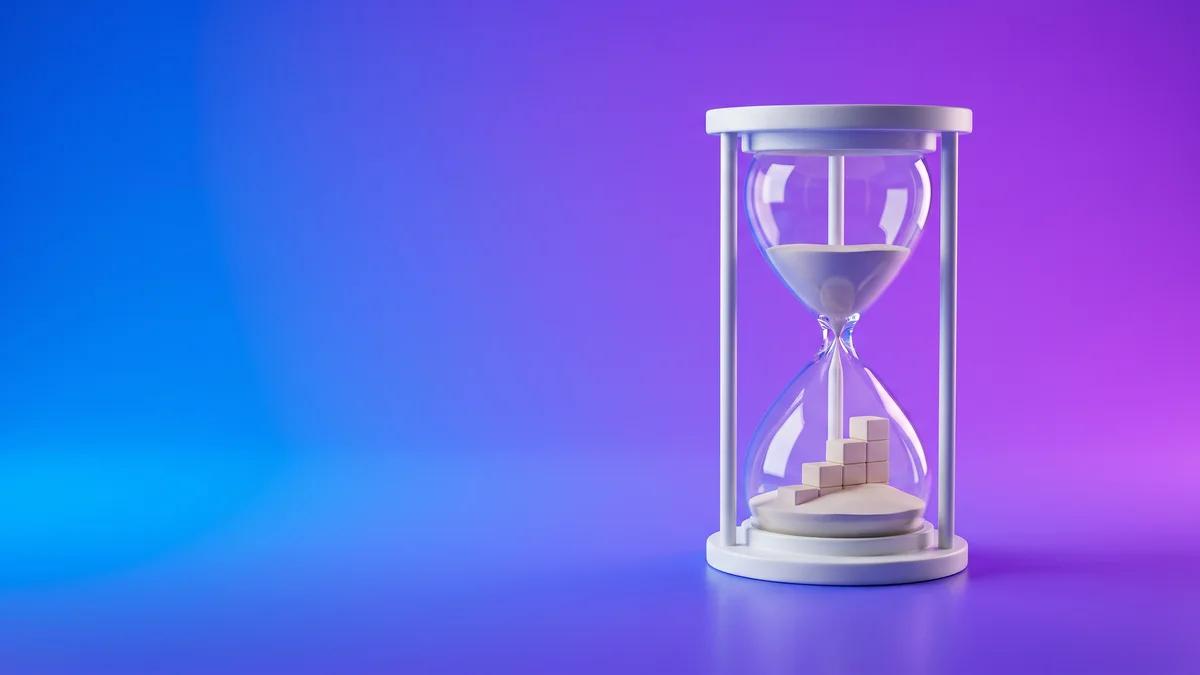 An hourglass with the fallen sand forming a rising staircase, representing how long SEO takes to work