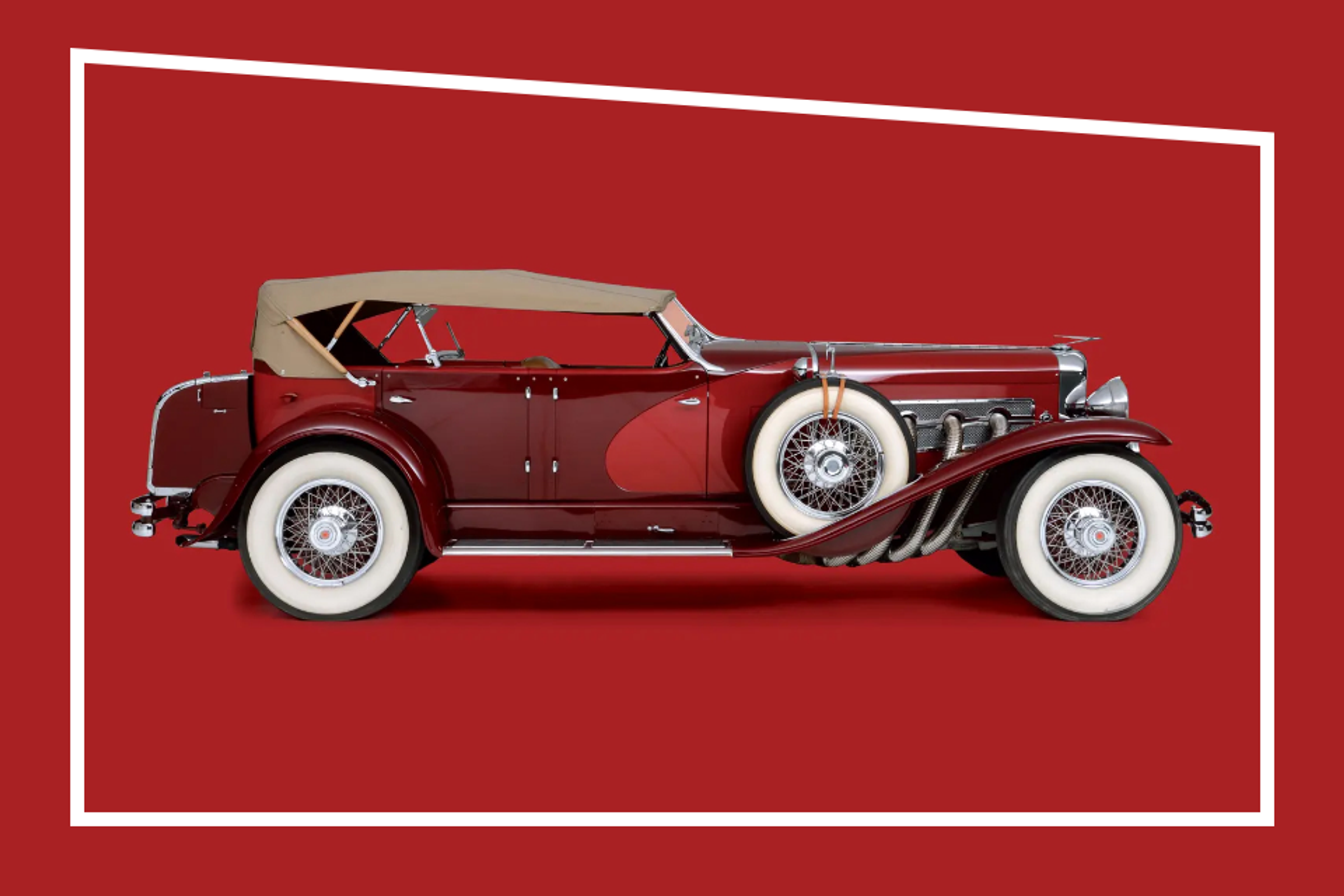Red Duesenberg car with white wheels and beige top side view in red studio