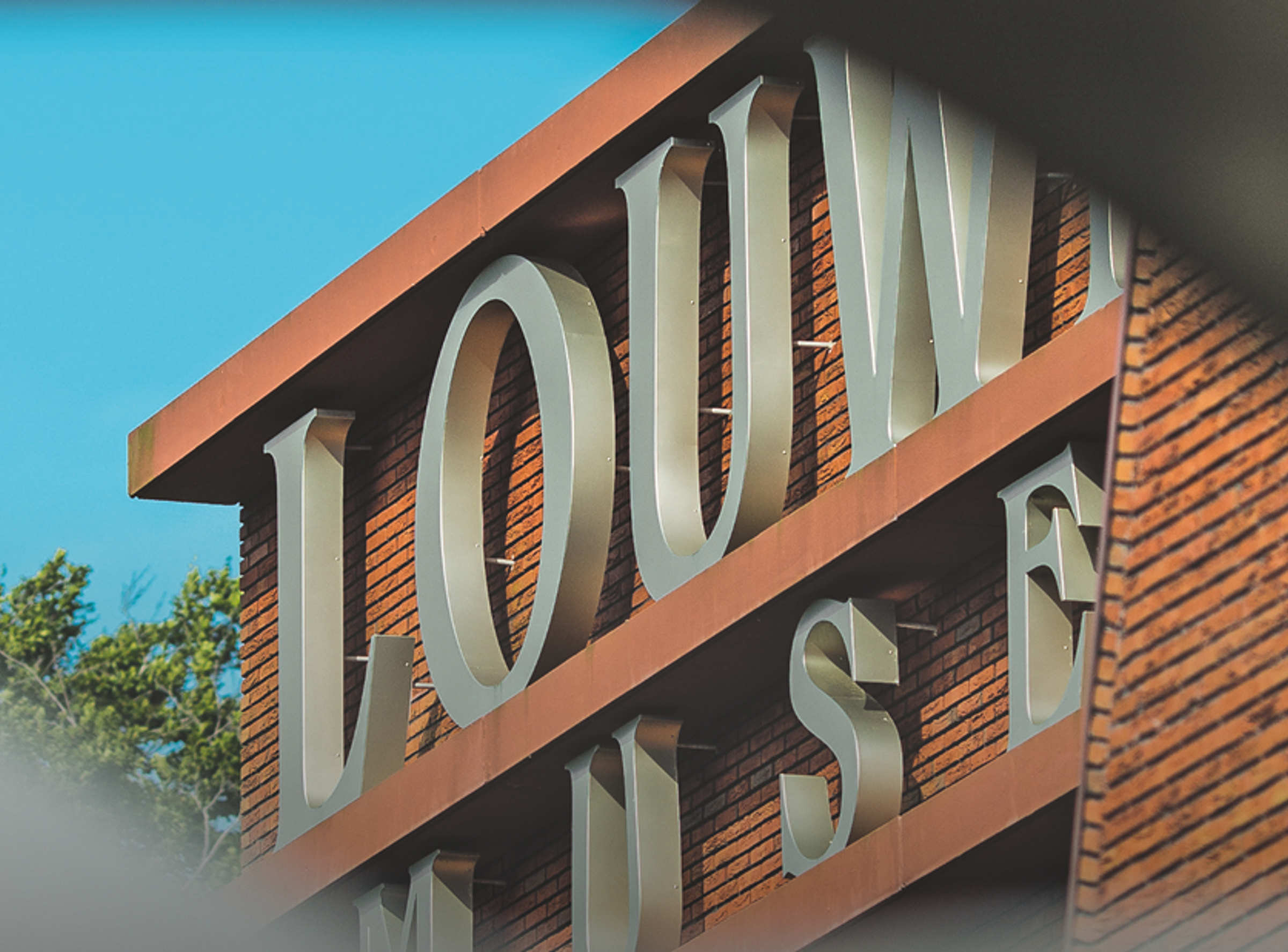 Doorkijkje naar klein deel van de voorgevel met het logo van het Louwman Museum