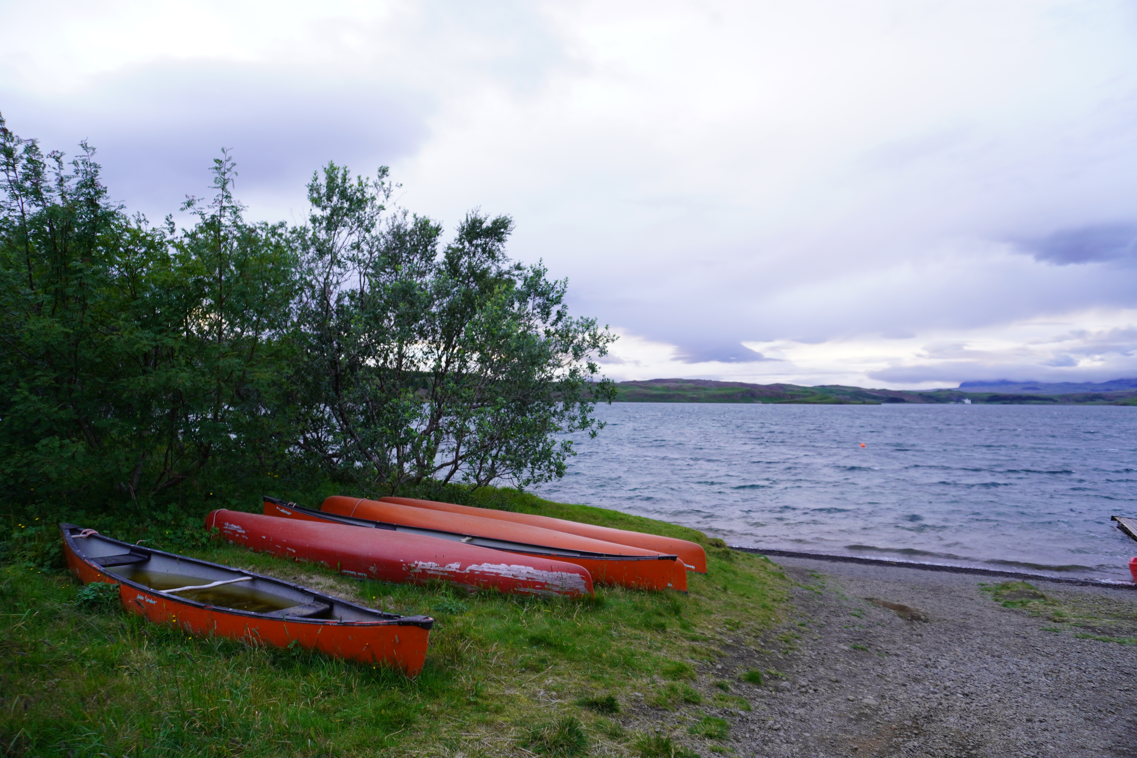 orange canoes by a lake