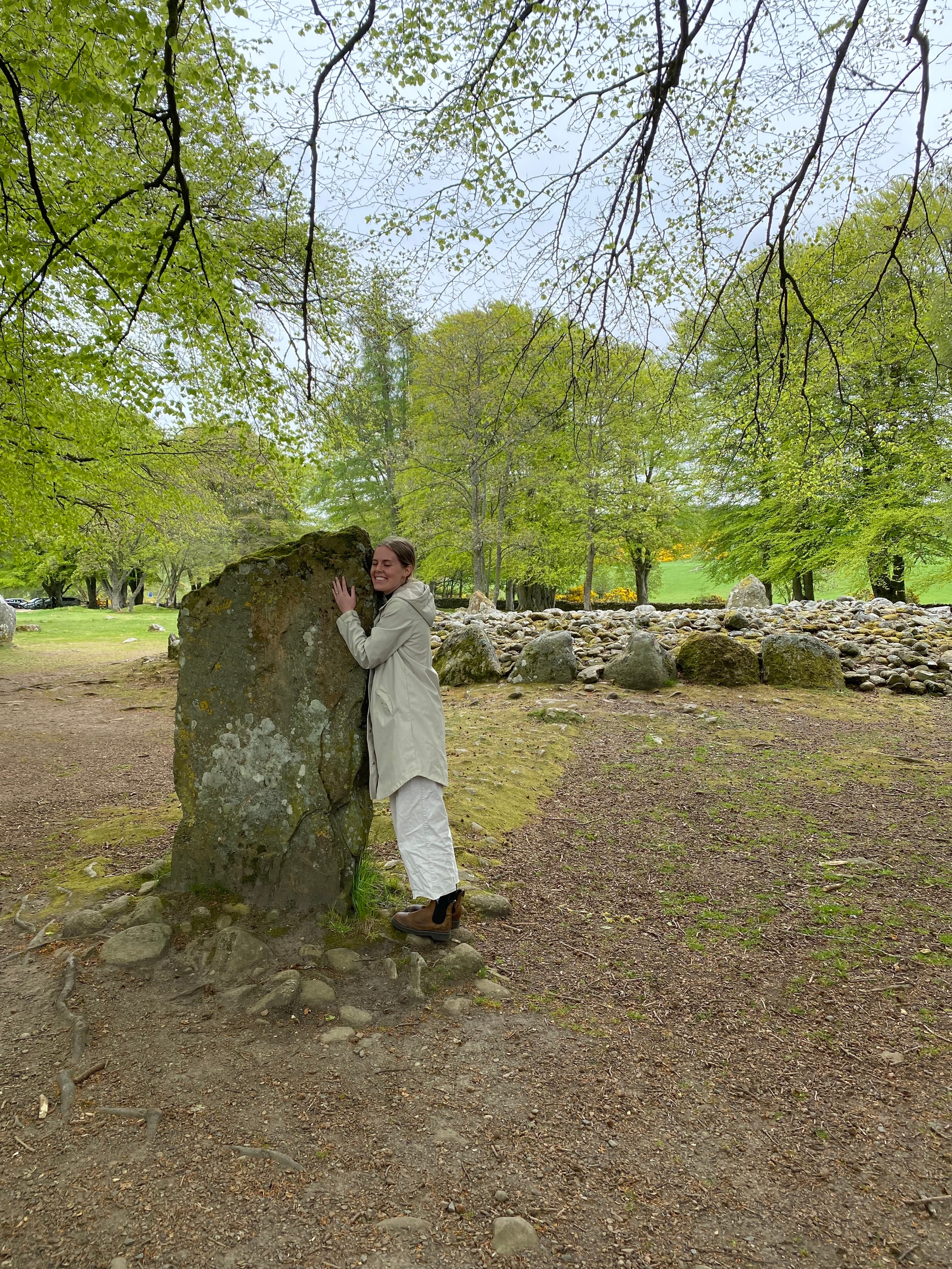 Phoebe hugging a standing stone