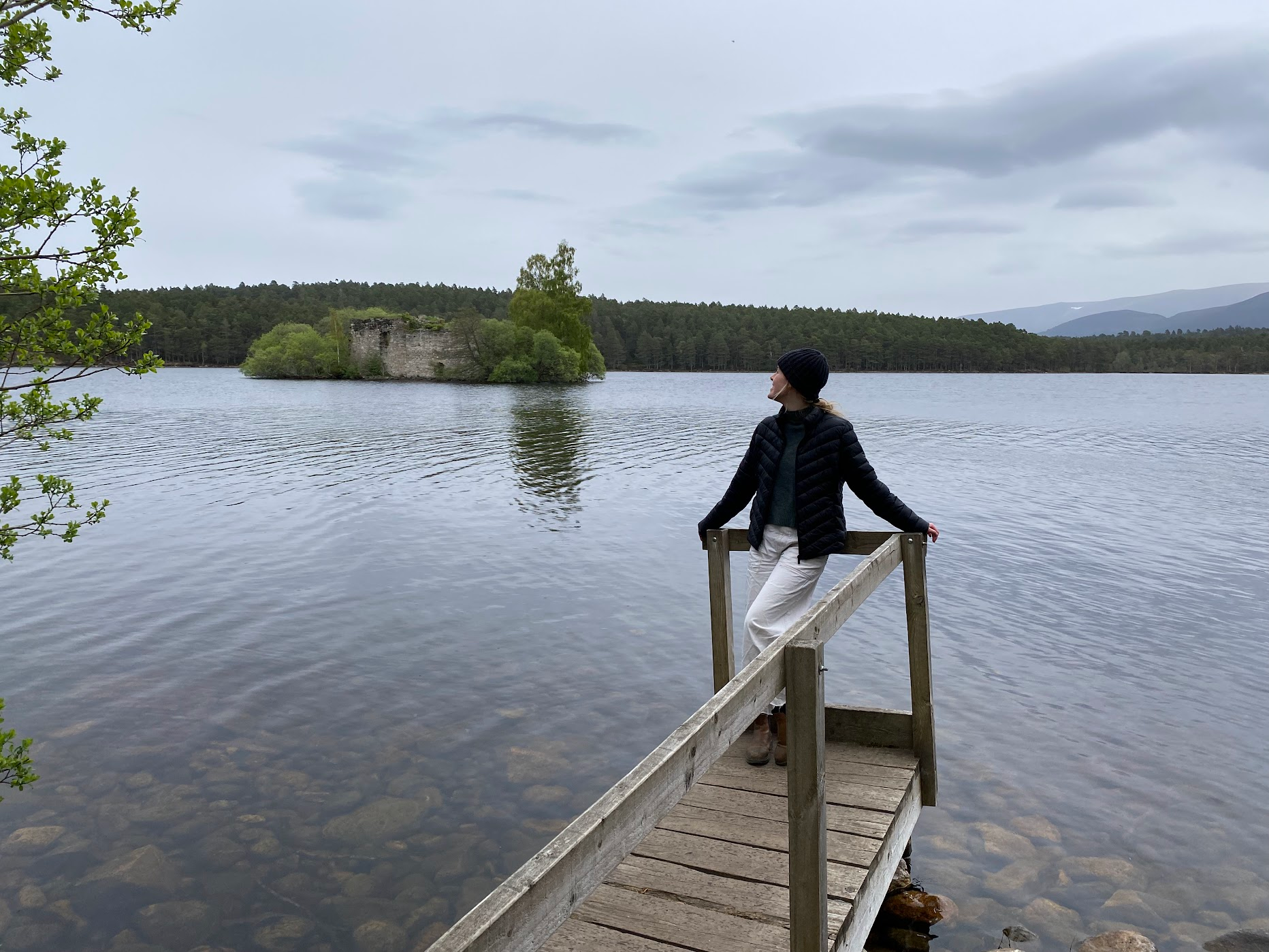 Phoebe standing near a beautiful Lake