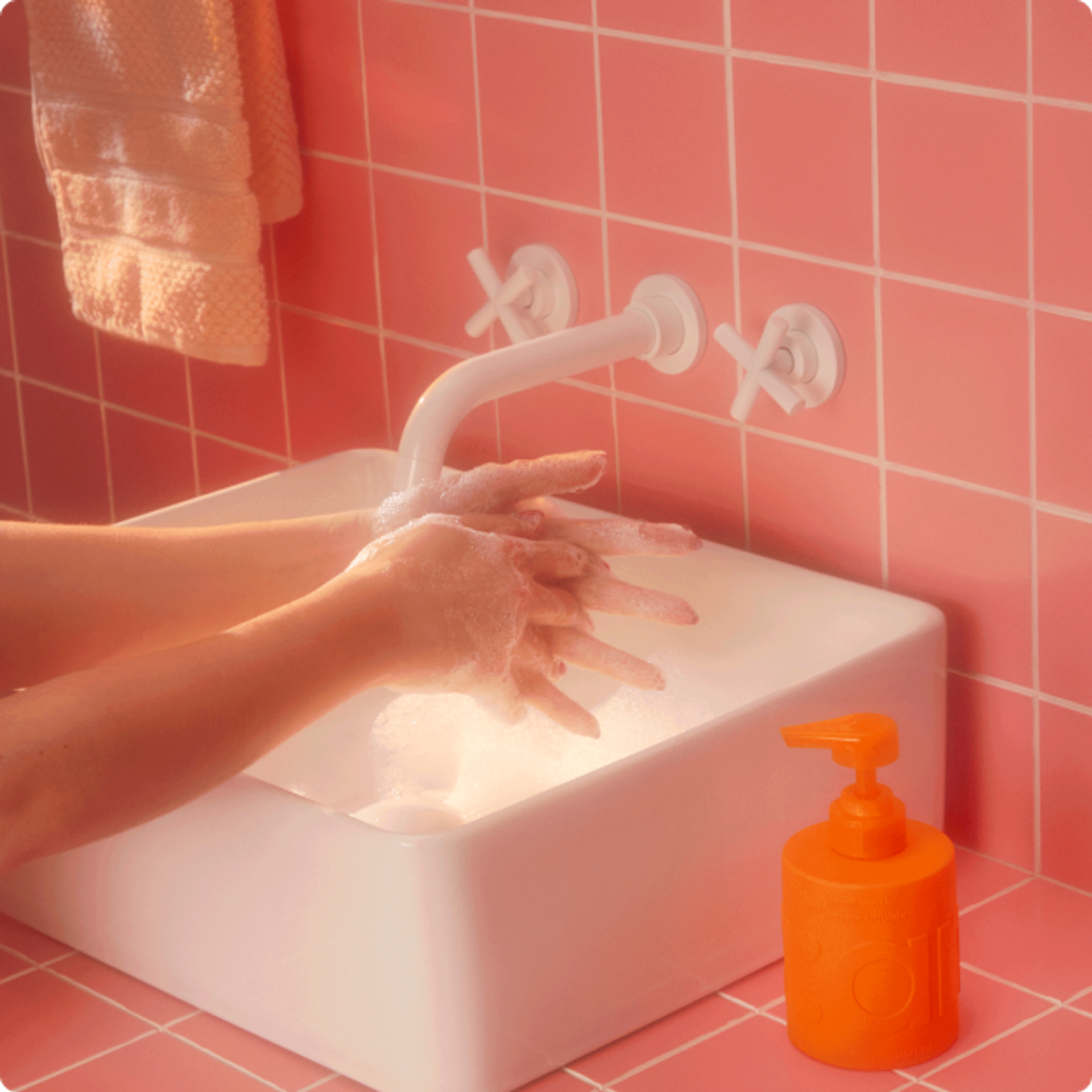someone washing hands with amika hand wash