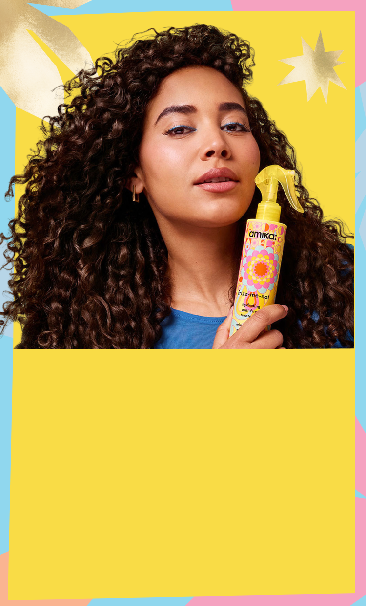 a model holds a bottle of amika frizz-me-not treatment against a yellow background with a pastel and gold patterned border
