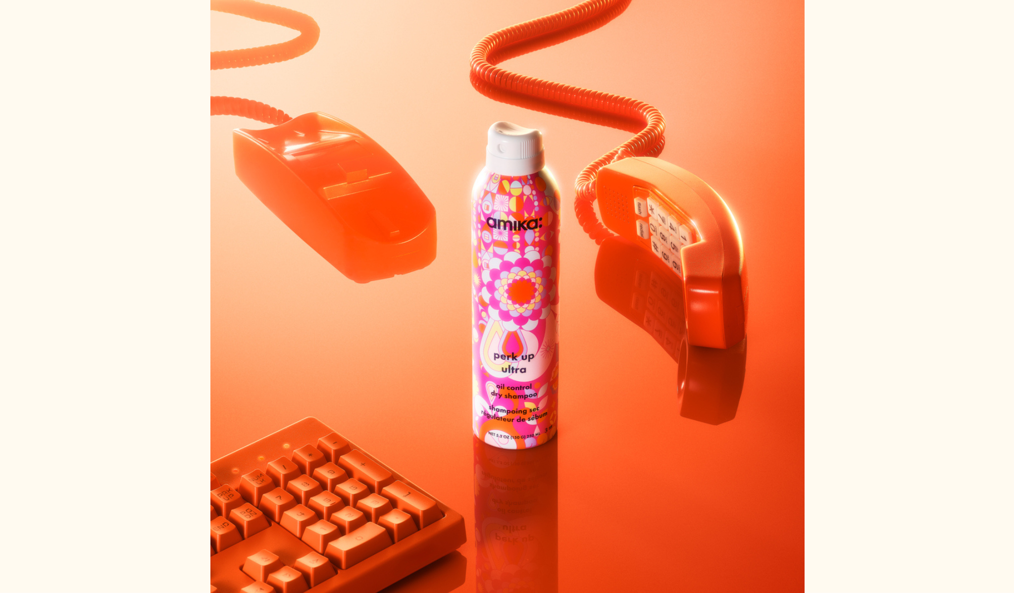 stylized image of a telephone, keyboard and amika's new perk up ultra oil control dry shampoo 5.3 oz bottle