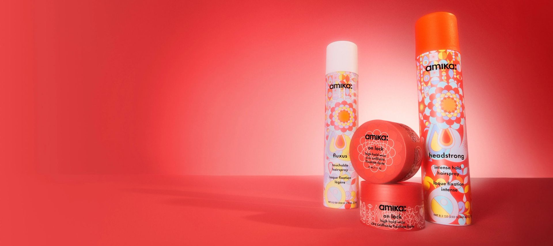 amika hold products collection: fluxus hairspray, headstrong hairspray, and on lock high hold hair wax