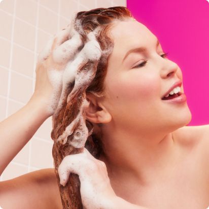 image image of a model washing and lathering her hair