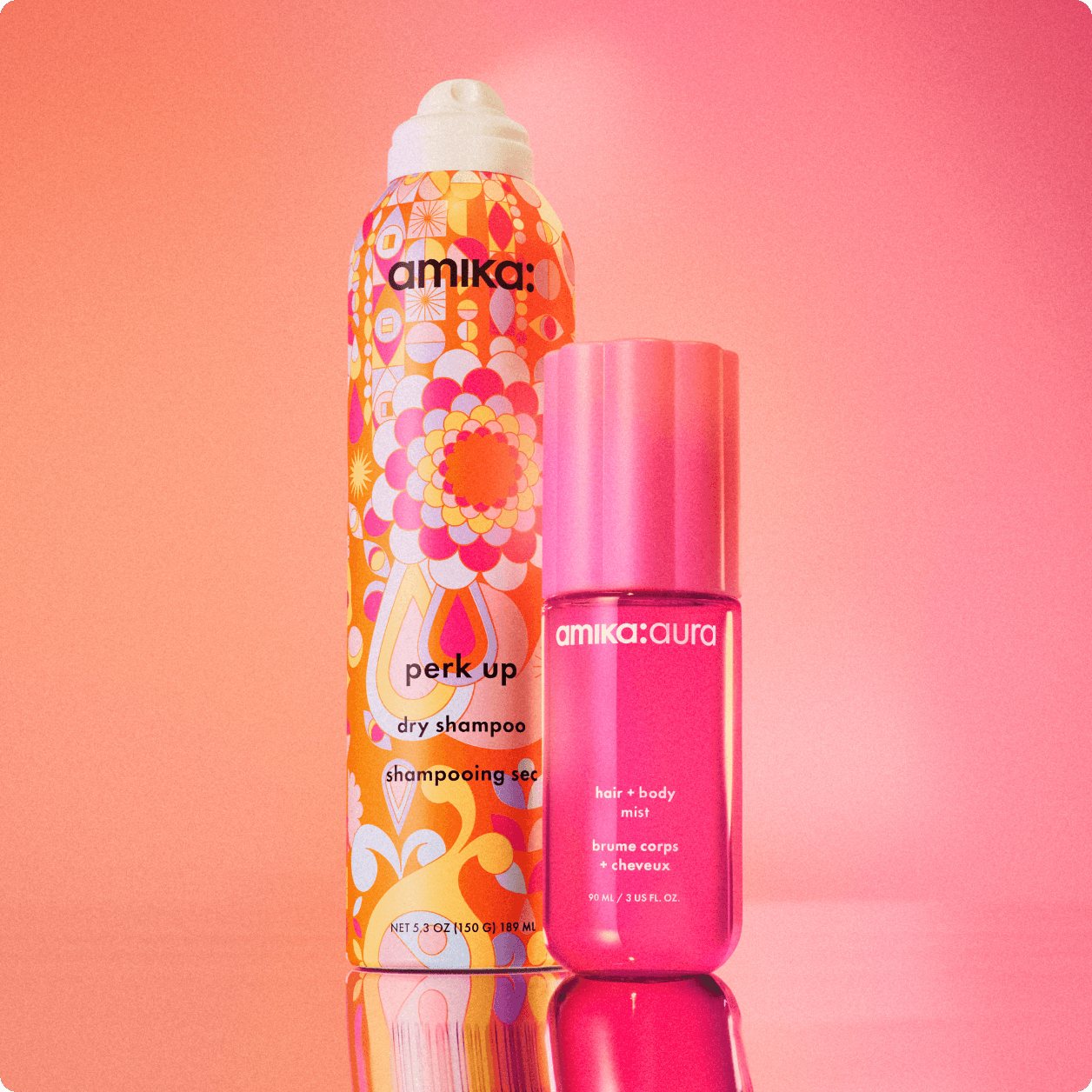 image of amika aura and perk up dry shampoo against a pink and orange background.