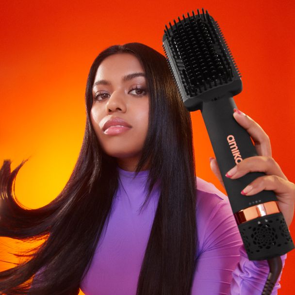 model with double agent 2-in-1 hair dryer and straightening brush