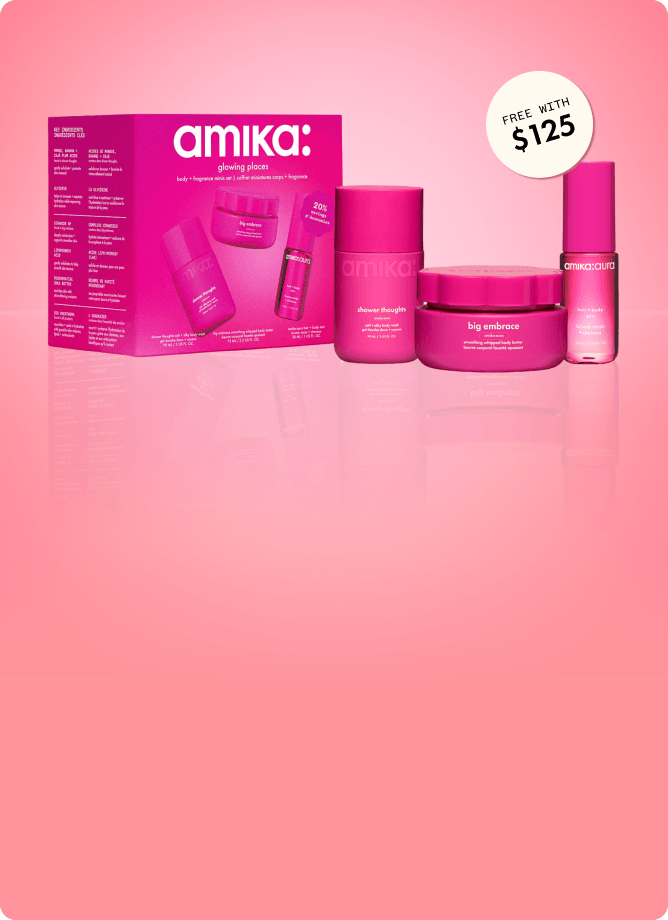 amika glowing places body + fragrance minis set stands against a pink background. a sticker reads: "free with $125" (orders)