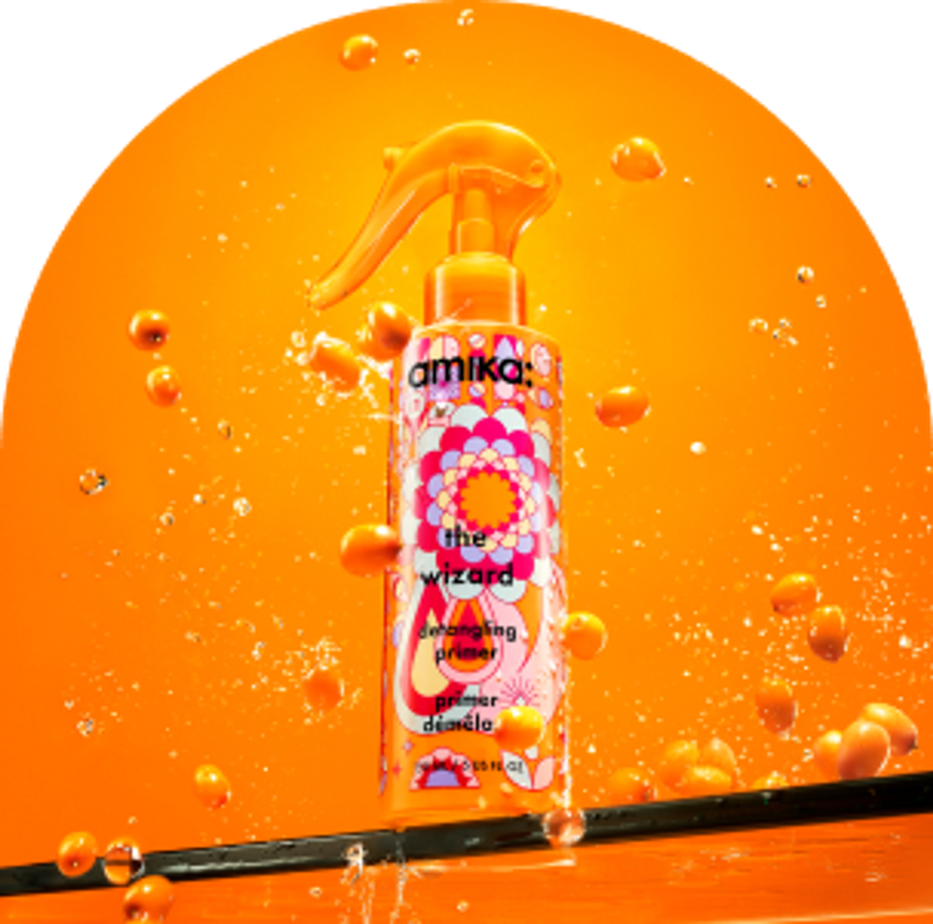 amika the wizard detangling primer against a n orange backgound with splashes of water and sea buckthorn berries floating