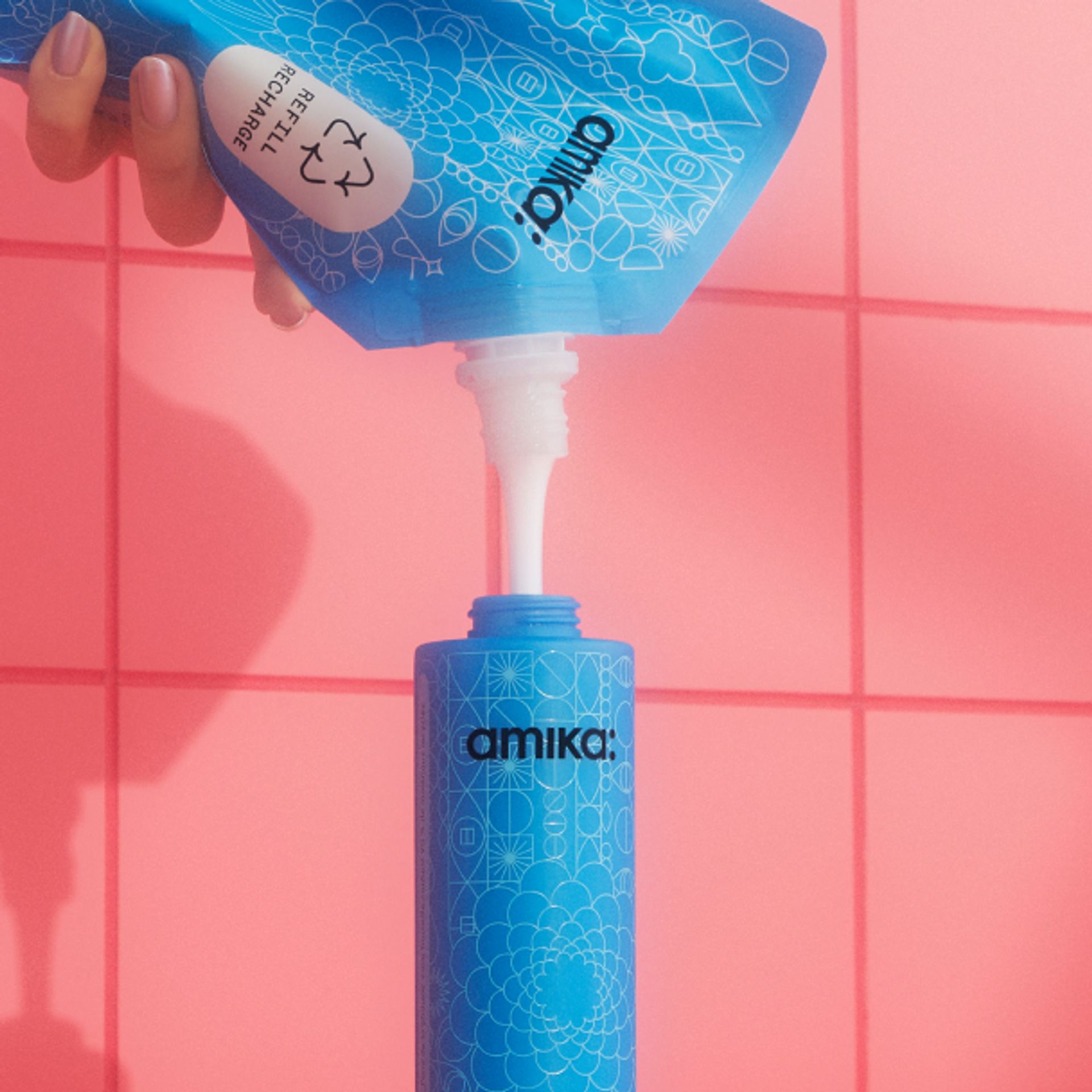 hand pouring refill shampoo pouch into bottle