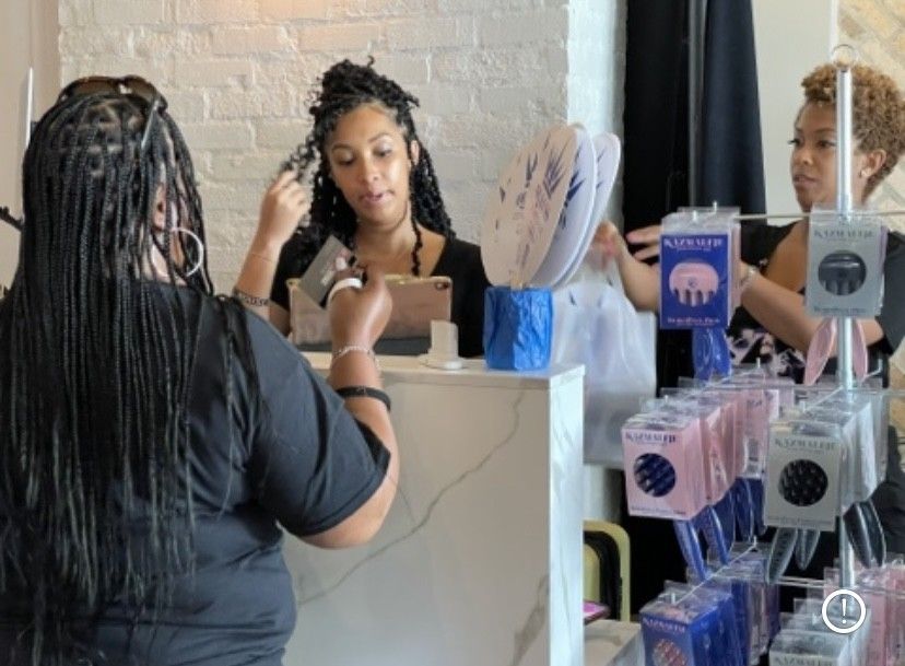 a person holds a credit card purchasing hair care items