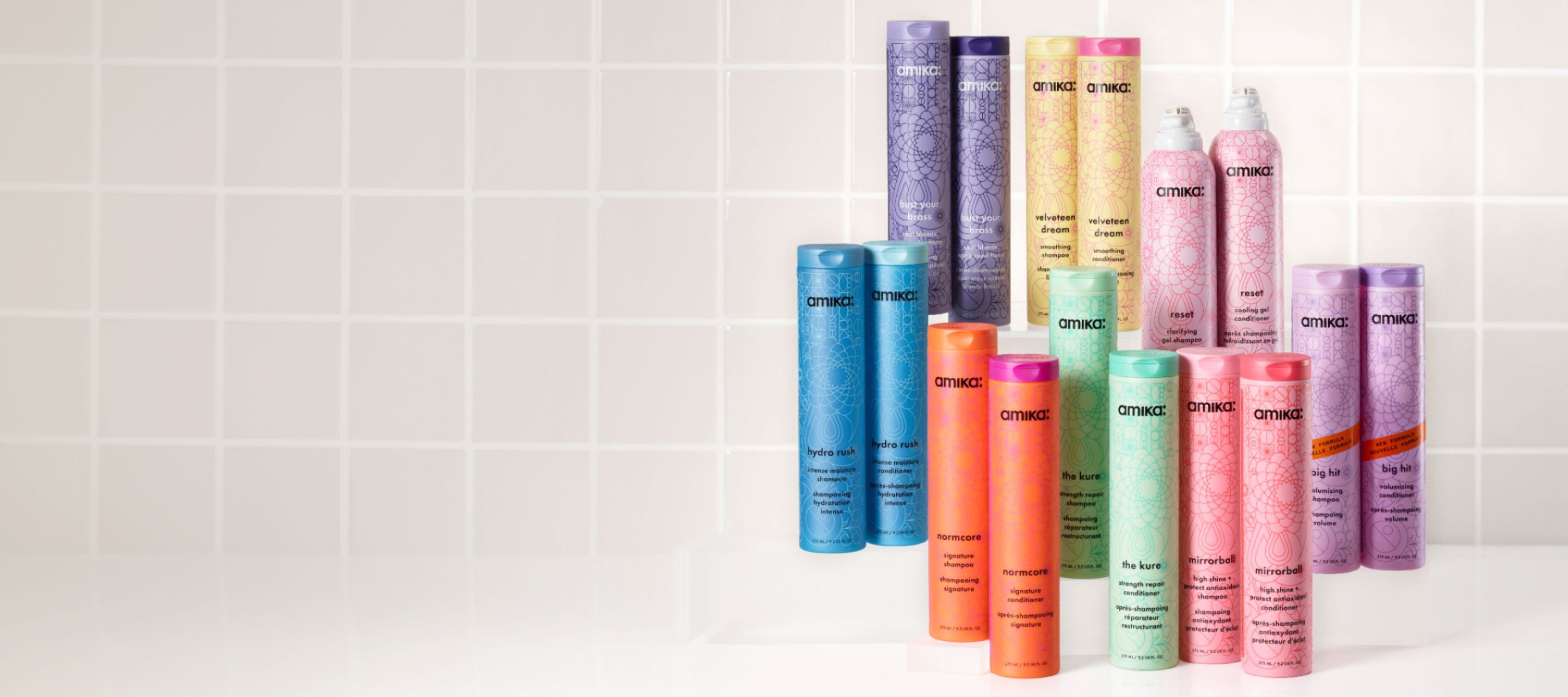 a collection of amika shampoo and conditioners on a white background