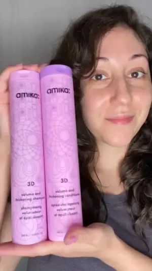 person holding 3d volume and thickening shampoo and conditioner