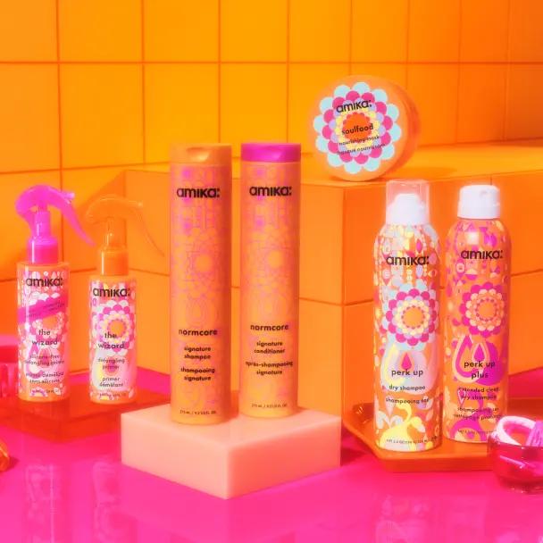 signature collection on a pink counter with an orange tile background