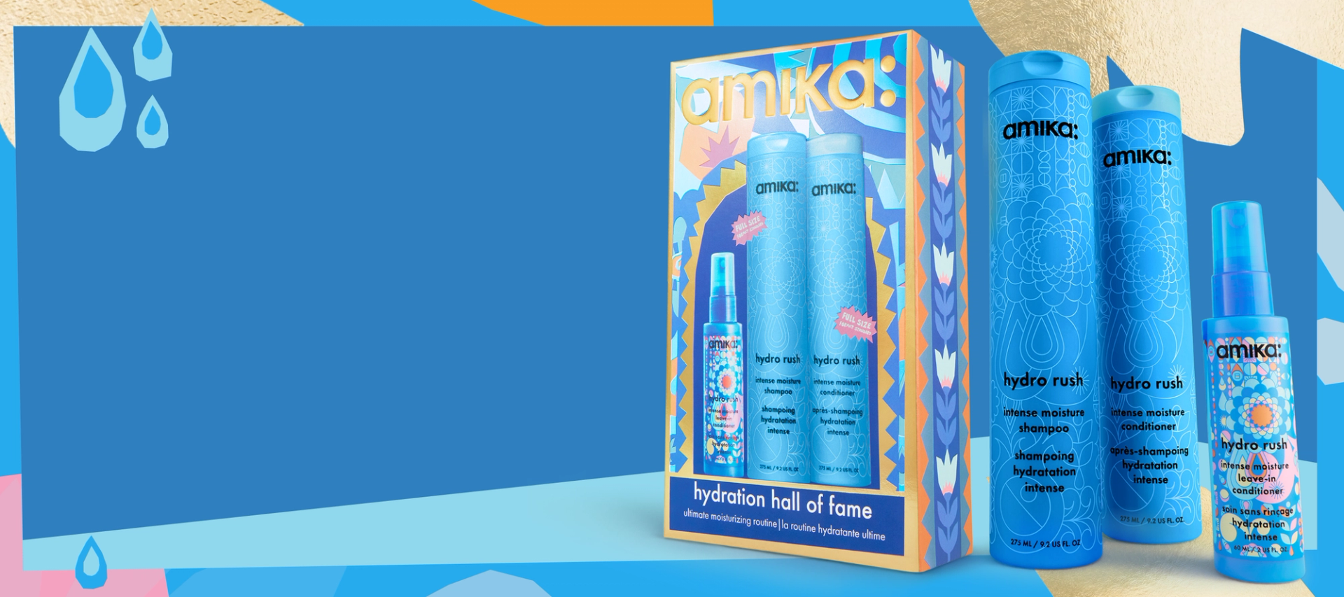amika hydration hall of fame gift set box and products that are included- hydro rush shampoo, conditioner, and leave-in conditioner against a blue background. a pastel patterned border is around the image