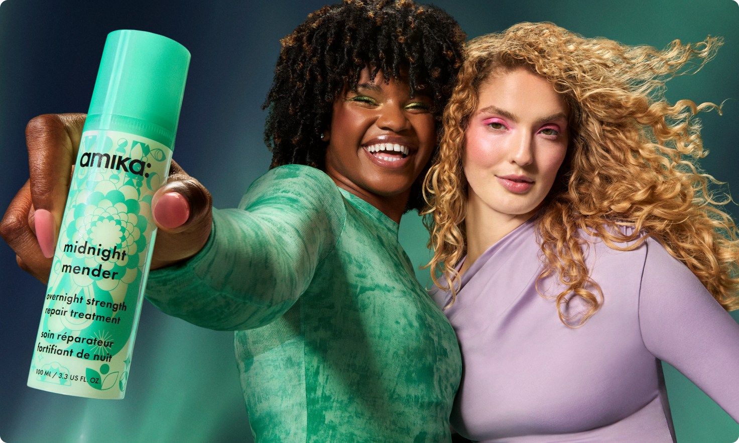 two models pose with a bottle of midnight mender overnight strength repair treatment