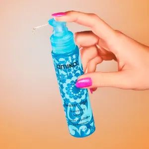 hand pumping water sign hydrating hair oil bottle