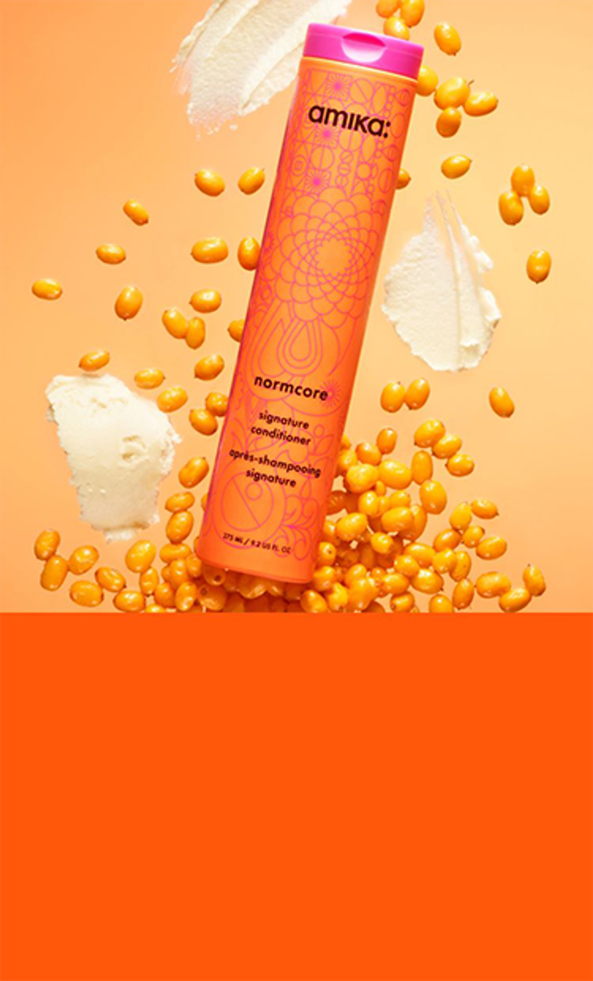 bottle of amika normcore nourishing vegan conditioner against and orange background with sea buckthorn berries