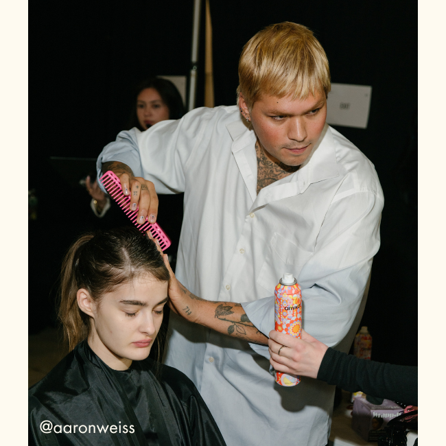 a stylist uses amika products at the sandy liang fashion show 2025