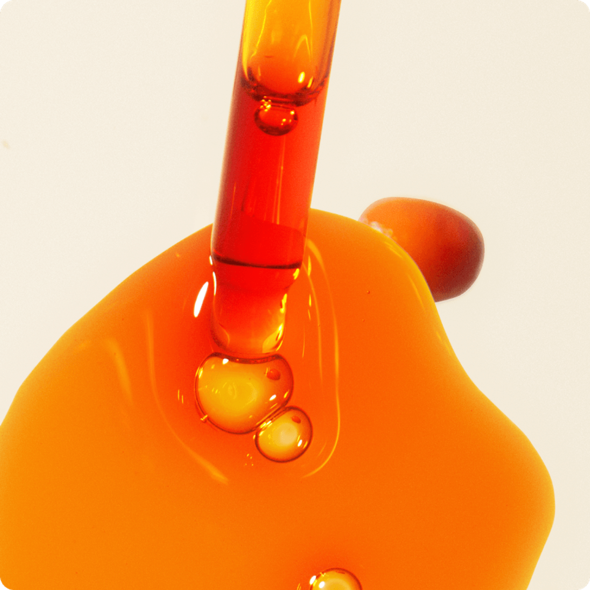 a dropper and a bit of sea buckthorn seed oil on a white background. a sea buckthorn berry is nearby