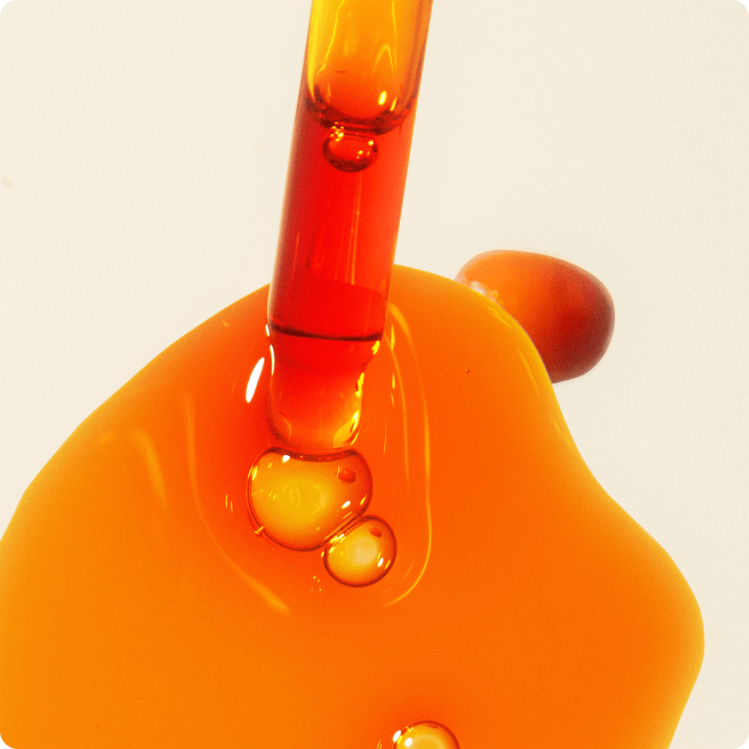 a dropper and a bit of sea buckthorn seed oil on a white background. a sea buckthorn berry is nearby