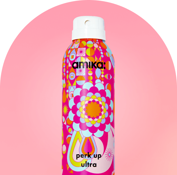 amika perk up ultra bottle against a pink background