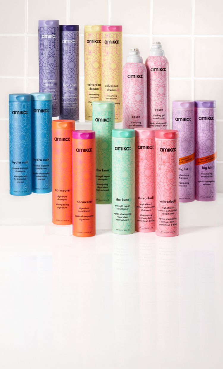 a collection of amika shampoo and conditioners on a white background