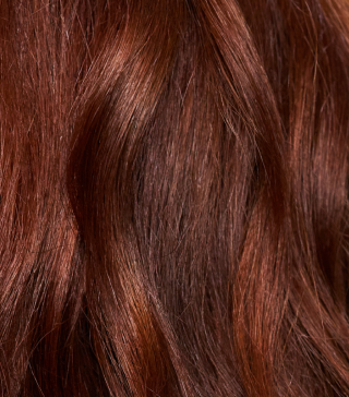 close up of smooth, shiny, red, wavy hair