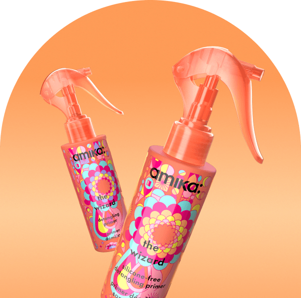 bottles of amika the wizard float against an orange background